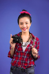 Woman travel. Young beautiful asian woman traveler taking pictures on blue background