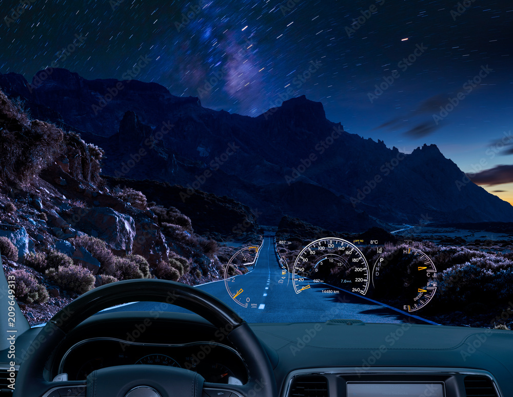 Wall mural car equipped with a hud display driving at night along a mountain road .the concept of a modern car