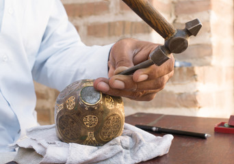 craftsman engraving patterns on the jug. masters of Central Asia. manual copper minting