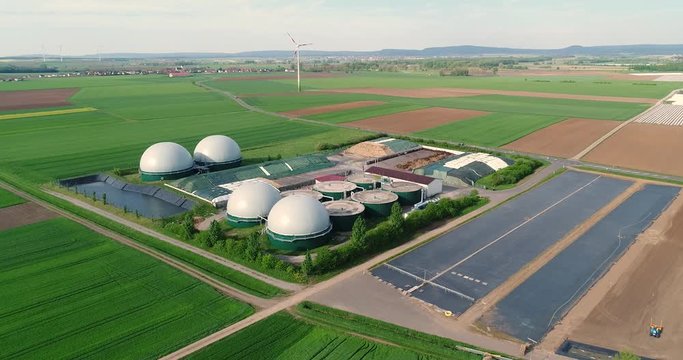 Camera flight over biogas plant from pig farm. Renewable energy from biomass. Modern agriculture European Union. aerial view, panoramic view from the air