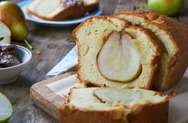 Slices of cake with pears on a wooden board