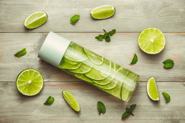 Health care, fitness, healthy nutrition diet concept. Fresh cool lemon mint infused water, cocktail, detox drink, lemonade in a glass jar for spring summer days. Light background