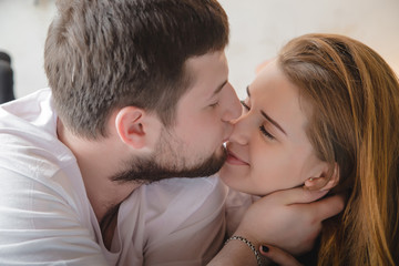 Lovely couple have fun, rest and relax on the bed together