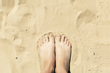 Feet in the sand. Summer vacation concept