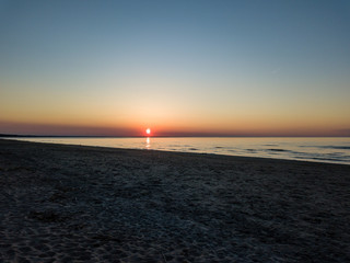 Fototapeta premium drone image. aerial view of red sunset in the sea. shore line