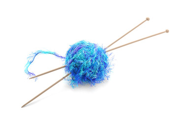 Ball of thread with knitting needles on white background