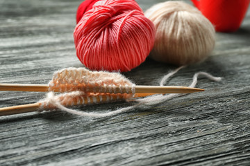 Knitting yarn with needles on wooden table