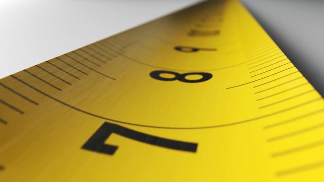 Camera moves along the yellow tape measure in endless loop. Close-up shot.
