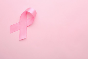 Pink ribbon on color background. Breast cancer concept