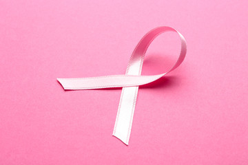 Pink ribbon on color background. Breast cancer concept