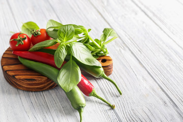 Fresh vegetables and spices on wooden background
