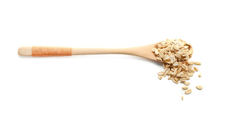 Spoon with raw oatmeal on white background