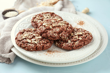 Plate with delicious oatmeal cookies on table