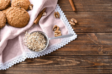 Fototapeta na wymiar Composition with delicious oatmeal cookies on wooden background