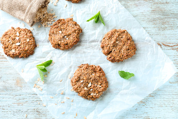 Delicious oatmeal cookies on wooden background