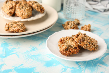 Plate with delicious oatmeal cookies on table