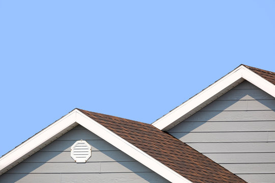 Grey house and blue sky