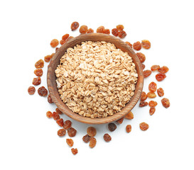 Bowl with raw oatmeal and raisins on white background