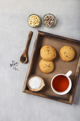 Tea with Sugar, Chocolate Chip Cookies and Dry Fruits. Served in a Wooden Tray.