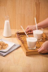 Milk bottle and milk glass on wooden table. Healthy eating concept