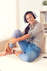 Smiling woman listening to music with headphones