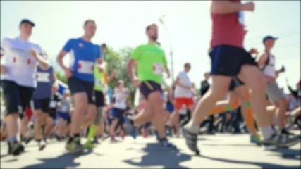 Blurred video. Race of a lot of people. Legs of runners in the marathon. Healthy lifestyle. Hardy athletes competition.