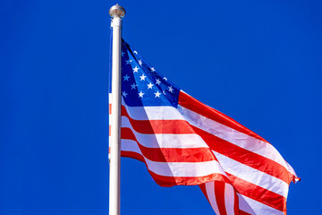 American Flag against blue sky.