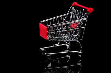 Empty shopping cart on black background