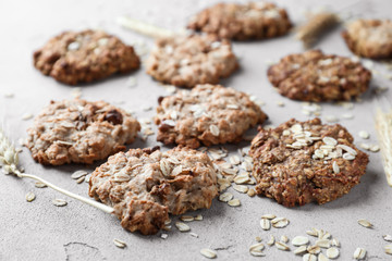 Delicious oatmeal cookies on light background