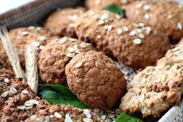Delicious oatmeal cookies on wicker tray, closeup