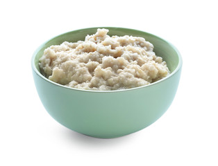 Tasty oatmeal in bowl on white background