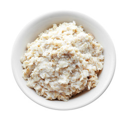 Tasty oatmeal in bowl on white background