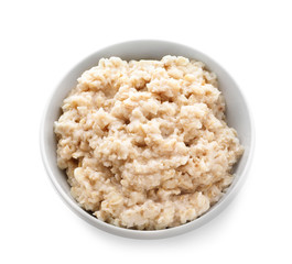 Tasty oatmeal in bowl on white background