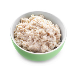 Tasty oatmeal in bowl on white background