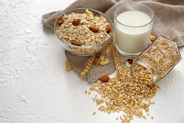 Composition with raw oatmeal on white textured background