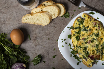 Omelet made from eggs, bacon, cheese and onion on plate