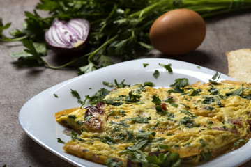 Omelet made from eggs, bacon, cheese and onion