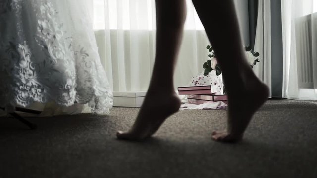 Beautiful young girl bare feet moving on interior in the living room in slow motion.
