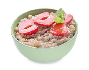 Fototapeta na wymiar Bowl with tasty oatmeal and strawberry on white background