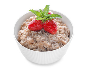 Bowl with tasty oatmeal and strawberry on white background