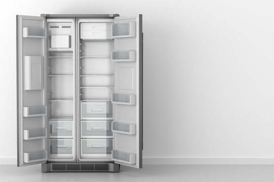 modern empty fridge in front of white wall