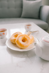 sugar donut and tea on white background
