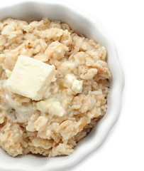 Bowl with prepared oatmeal on white background
