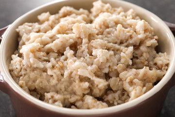 Tasty oatmeal in bowl, closeup