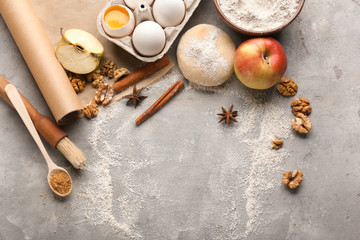 Fototapeta na wymiar Ingredients for preparing bakery on grey background