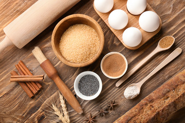 Bread with ingredients for preparing bakery on wooden table