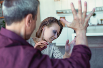 Suffering woman. Beautiful young woman with blue eye crying out loud while suffering from home abuse