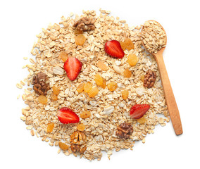 Heap of raw oatmeal with raisins, walnut and strawberry on white background