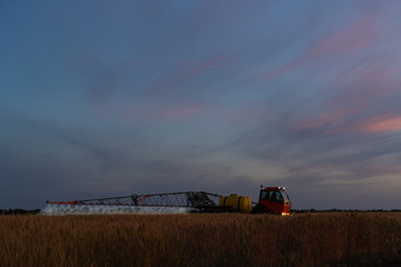 Fototapeta premium Machine for spraying pesticides and herbicides in the field at work