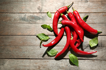 Fresh chili peppers on wooden background